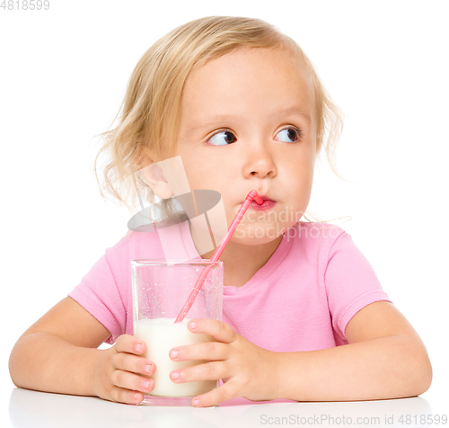 Image of Cute little girl with a glass of milk