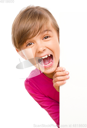 Image of Little girl is looking out from the blank banner