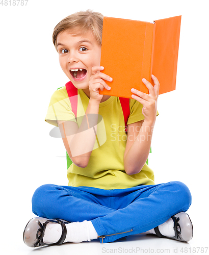 Image of Portrait of a cute little schoolgirl with backpack