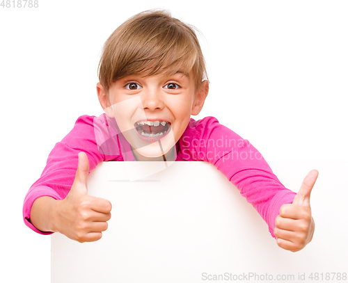 Image of Little girl is looking out from the blank banner