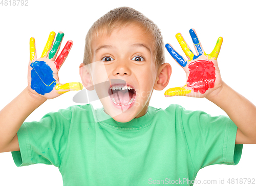 Image of Portrait of a cute boy playing with paints