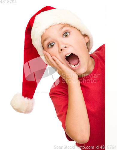 Image of Little girl is holding her face in astonishment