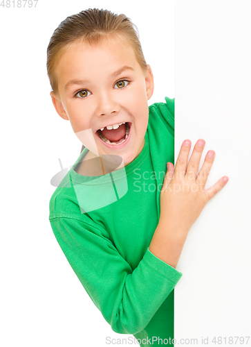 Image of Little girl is looking from out blank board