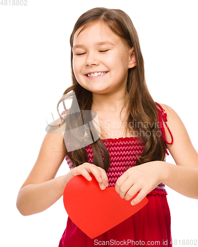 Image of Portrait of a sad little girl in red