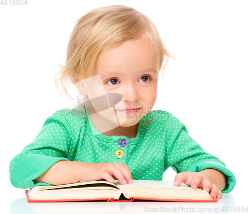 Image of Little girl is reading her book