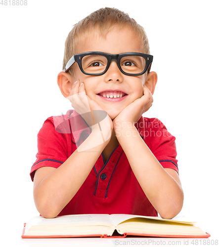 Image of Little boy is reading a book