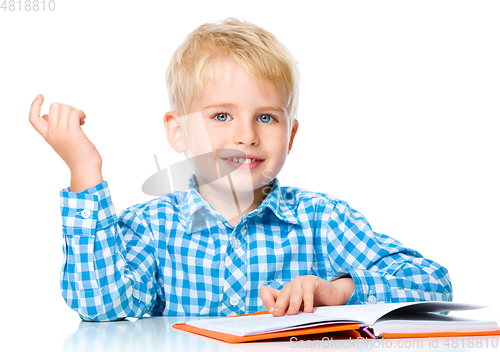 Image of Little child play with book