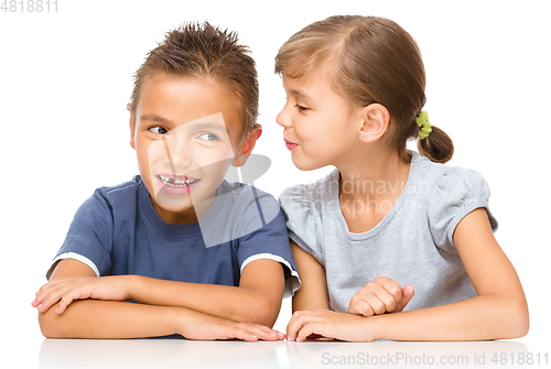Image of Little girl and boy are whispering in ear