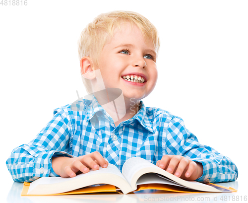 Image of Little child play with book