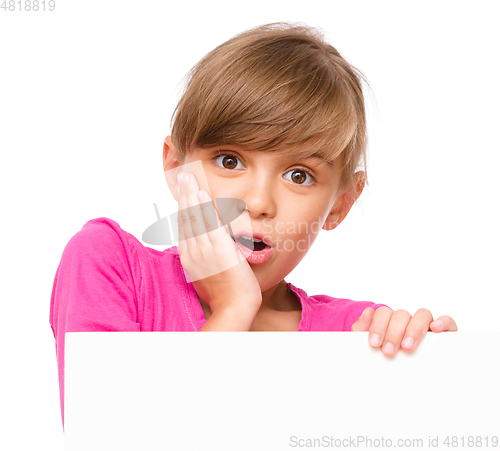 Image of Little girl is looking out from the blank banner