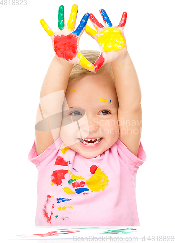 Image of Portrait of a cute little girl playing with paints
