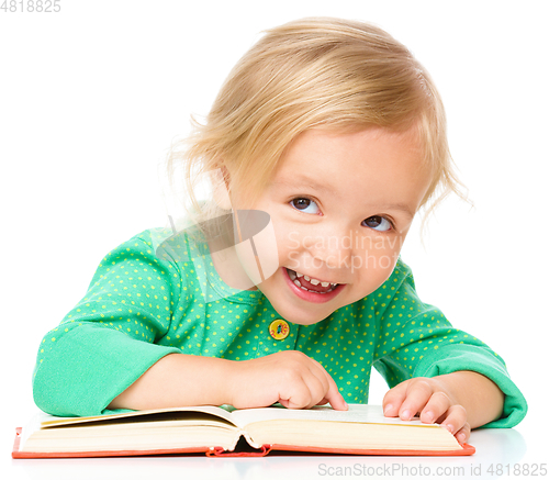Image of Little girl is reading her book