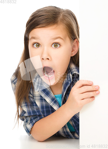 Image of Little girl is looking out from the blank banner