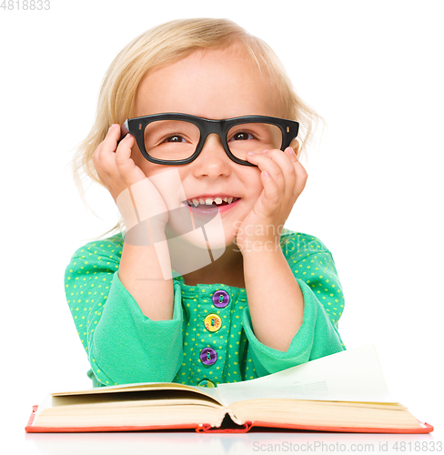 Image of Little girl is reading her book