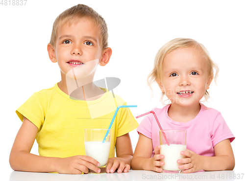 Image of Cute little girl and boy are drinking milk