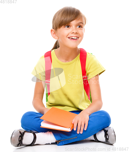 Image of Portrait of a cute little schoolgirl with backpack