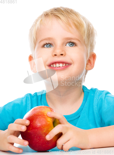 Image of Portrait of a cute little boy with red apple