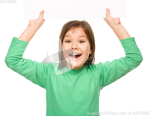 Image of Little girl is holding a blank banner