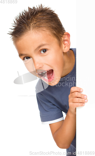 Image of Little boy is looking out from the blank banner