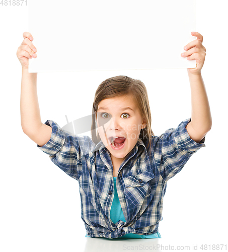 Image of Little girl is holding a blank banner