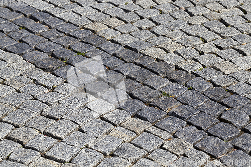 Image of two different colors of the type of blocks paved bridge. photo close-up. Dark line lie diagonally