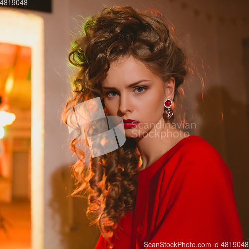 Image of beautiful blonde woman with red lips and curly hairs