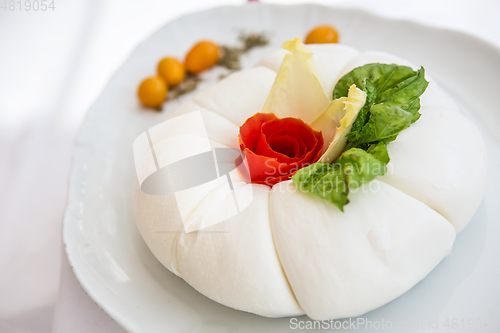 Image of Mozzarella with tomatos and basil leaves