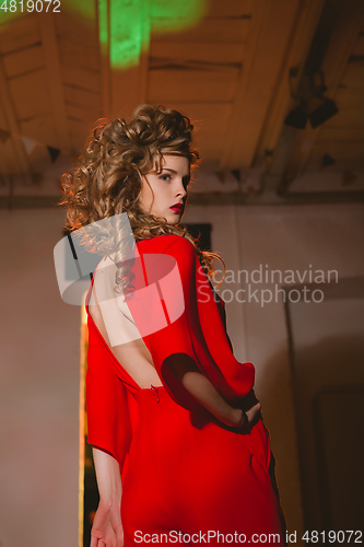Image of beautiful blonde woman with red lips and curly hairs