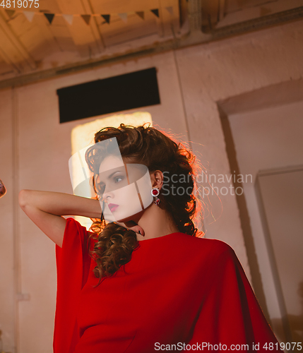 Image of beautiful blonde woman with red lips and curly hairs