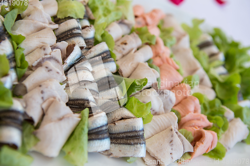 Image of Delicious appetizer canapes on board for celebratory table