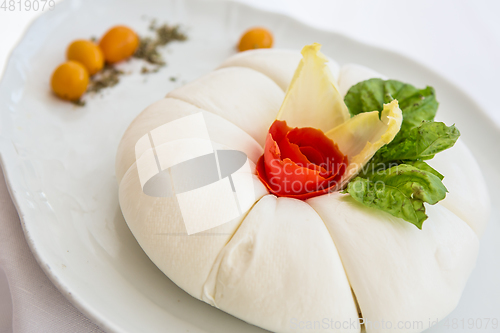 Image of Mozzarella with tomatos and basil leaves