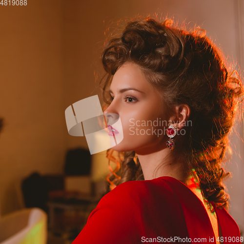 Image of beautiful blonde woman with red lips and curly hairs