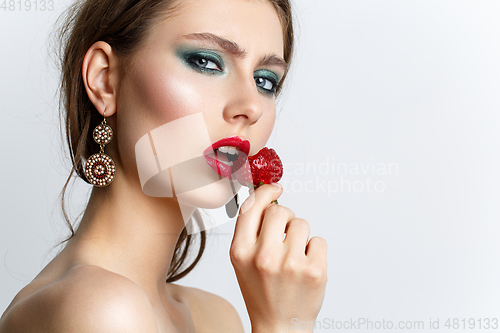 Image of beautiful girl with fresh strawberries