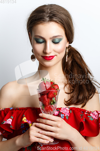 Image of beautiful girl with fresh strawberries