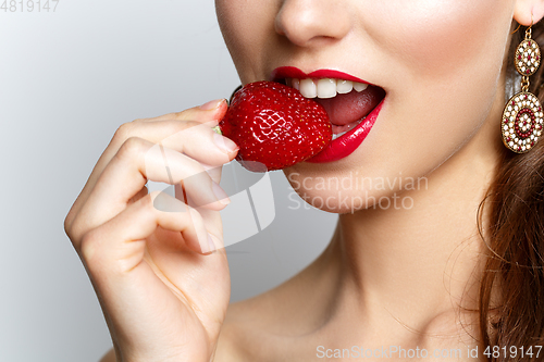 Image of beautiful girl with fresh strawberries