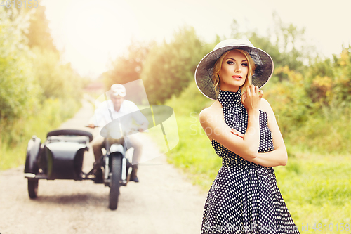 Image of beautiful couple on retro motorbike