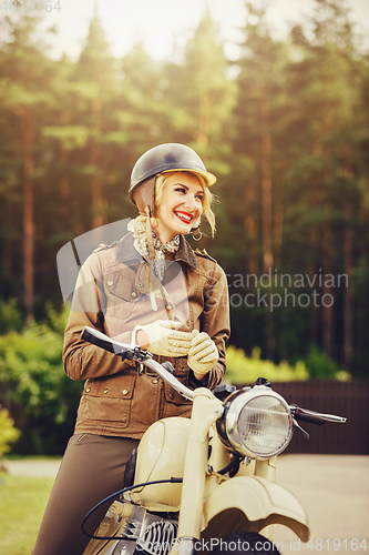 Image of beautiful girl on retro motorbike