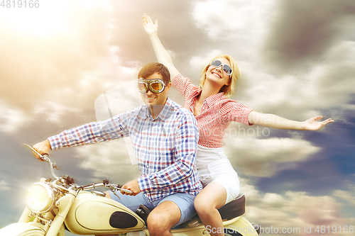 Image of beautiful couple on retro motorbike