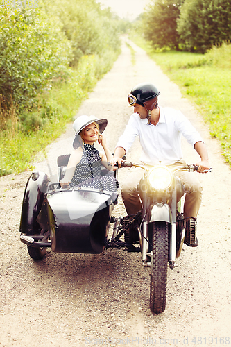 Image of beautiful couple on retro motorbike