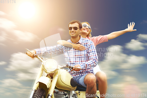 Image of beautiful couple on retro motorbike