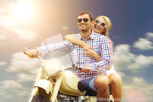 Image of beautiful couple on retro motorbike