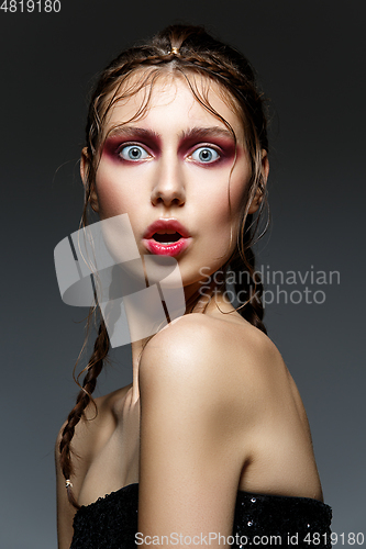 Image of beautiful girl with modern braids and red makeup