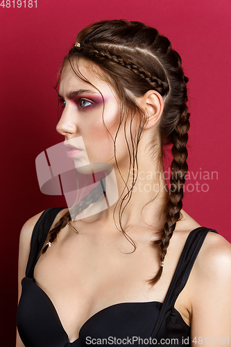 Image of beautiful girl with modern braids and red makeup