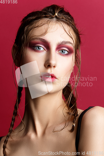 Image of beautiful girl with modern braids and red makeup