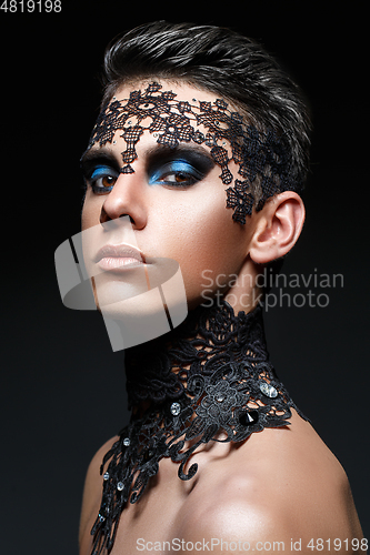 Image of handsome young man with lace on face