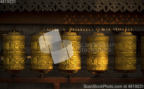 Image of Rotating buddhist prayer wheels as symbol of buddhism religion