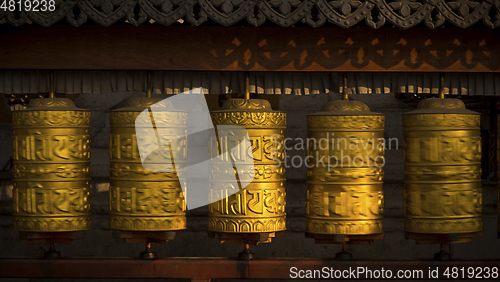Image of Rotating buddhist prayer wheels as symbol of buddhism religion