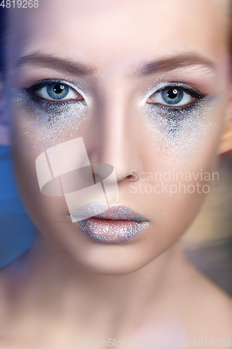 Image of beautiful blond girl with sparkling makeup