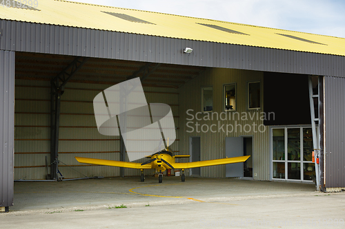 Image of small plane standing in shed