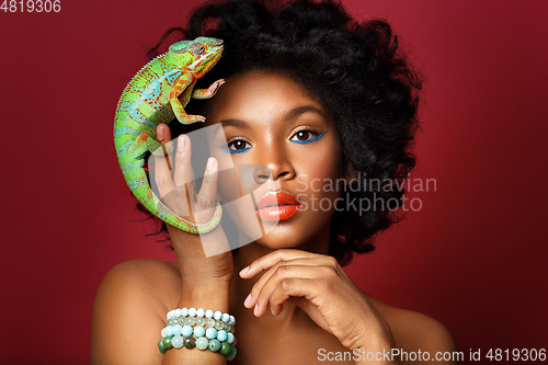 Image of beautiful girl with chameleon